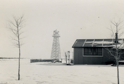 Barracks and water tower in the snow (ddr-densho-159-218)