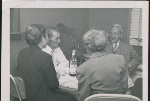 Four people seated at a table (ddr-densho-293-102)