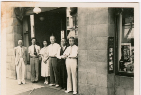Five men and a woman standing outside business (ddr-densho-426-2130)