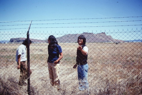 Pilgrims examining a barbed wire fence at Tule Lake (ddr-densho-294-57)