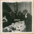 Two men shaking hands over table (ddr-densho-410-553)
