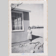 Woman standing outside barracks (ddr-densho-464-46)