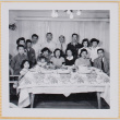 Group of adults and children posing by dinner table (ddr-densho-522-553)
