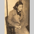 Sanae Okada seated in a chair (ddr-njpa-4-1995)