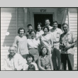 Group of 11 by door to house (ddr-densho-523-391)