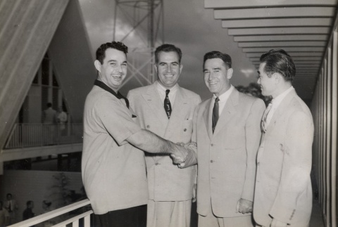Malcolm MacNaughton posing with three men (ddr-njpa-2-643)