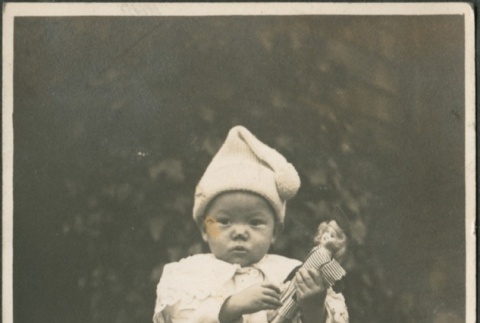 A baby holding a doll (ddr-densho-321-570)