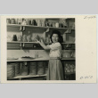 Mary Sakai in a pantry store room (ddr-densho-37-2163)