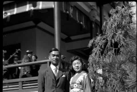 Tomoye (Nozawa) Takahashi with unknown man outside Japanese Pavilion at the Golden Gate International Exposition (ddr-densho-426-1987)