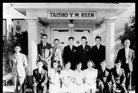 Group in front of the Taisho Y.M. Association building (ddr-csujad-55-1596)