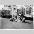 Group sitting on lawn in front of house (ddr-densho-1007-44)