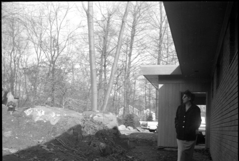 Woman standing next to unfinished house (ddr-densho-377-1401)