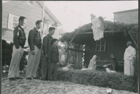 Four Sakura brothers look at nativity scene (ddr-densho-523-264)