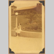 Grace poses by a building (ddr-densho-542-134)