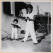 Susan Shiomi playing with toy gun with William Shiomi (ddr-densho-522-272)