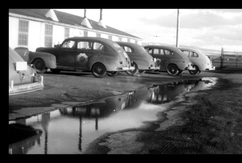 Cars parked next to building in Tule Lake (ddr-csujad-55-2234)