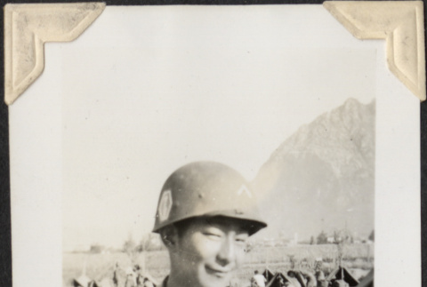 Man in helmet with tents in background (ddr-densho-466-713)