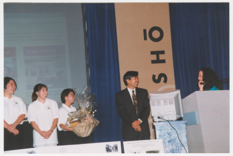 Staff giving Tom Ikeda a gift basket at Densho Opening Gala (ddr-densho-506-123)