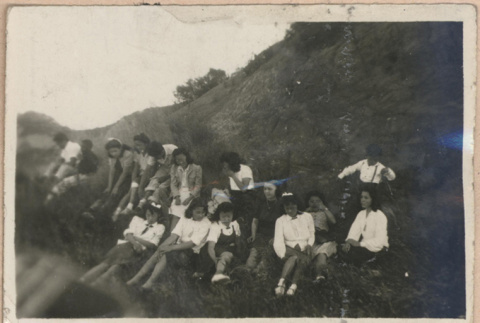 Young people sitting on a hillside (ddr-manz-10-3)