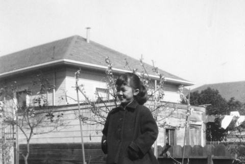 Carol Sato standing in yard (ddr-ajah-6-207)