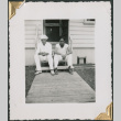 Phil Jackson and unidentified man sitting on steps (ddr-densho-434-176)