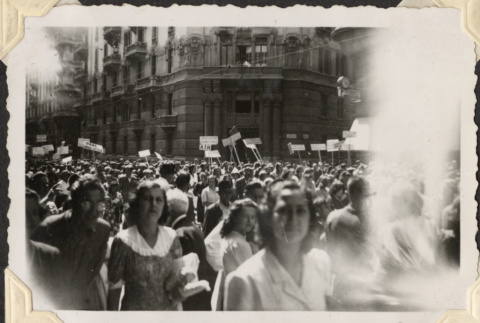 Crowd in street with signs (ddr-densho-466-634)