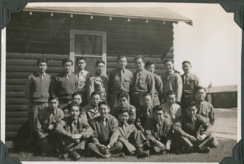 Men posing for group photo outside camp building (ddr-ajah-2-504)
