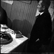 Man standing by table of food (ddr-densho-426-2152)