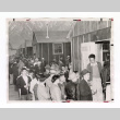 Nisei men gathered in front of barracks at Manzanar (ddr-csujad-52-7)