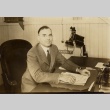 Man posing at his desk (ddr-njpa-2-924)