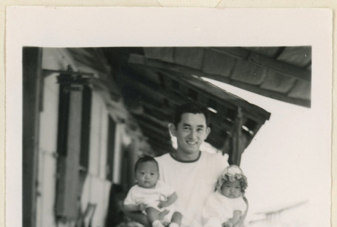 Joe Watanabe holding his twin babies (ddr-densho-37-1429)