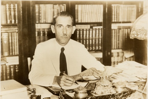 Ramon Grau seated at his desk (ddr-njpa-1-1789)