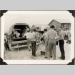 Men filming people climbing into back of truck (ddr-densho-587-81)