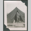 Man smoking a pipe inside a tent (ddr-densho-463-118)
