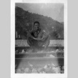 [Man in military uniform sitting on railroad tracks] (ddr-csujad-1-8)
