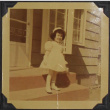 A girl standing on a front porch (ddr-densho-300-517)
