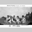 Shiota family sitting in a field (ddr-ajah-6-230)
