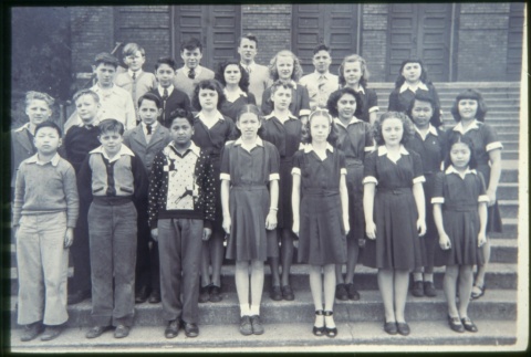 Group of boys and girls standing on steps of building (Maryknoll school) (ddr-densho-330-229)