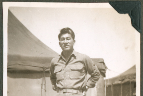 Soldier in front of tents (ddr-densho-201-536)