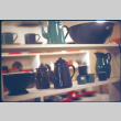 Display of enamelware coffee pots and cups (ddr-densho-426-318)