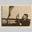 Man holding a film strip (ddr-densho-433-1243)