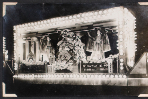 Display with two women in traditional garments framed by lights (ddr-densho-468-514)