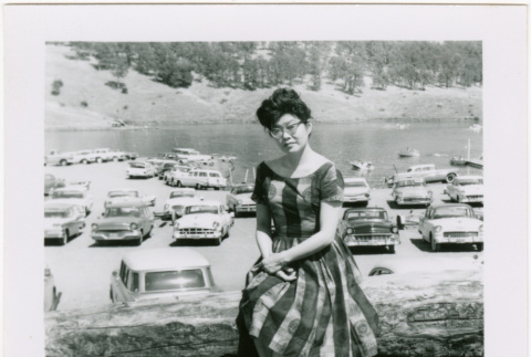 Tomoye (Nozawa) Takahashi sitting on log (ddr-densho-426-2198)