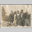 Four people standing by flower bed (ddr-densho-316-200)
