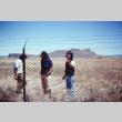 Pilgrims examining a barbed wire fence at Tule Lake (ddr-densho-294-57)