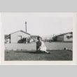 Woman sitting in front of school playground (ddr-manz-7-41)