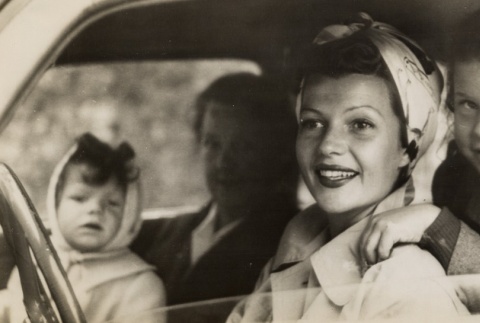 Rita Hayworth driving in a car with her daughters (ddr-njpa-1-581)