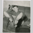Ted Akimoto relaxing on a couch (ddr-densho-299-256)
