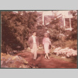 Agnes Sakura and man walking on garden path (ddr-densho-523-443)