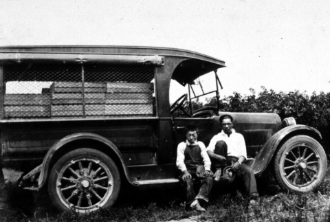 Two boys in front of a delivery truck (ddr-densho-18-7)